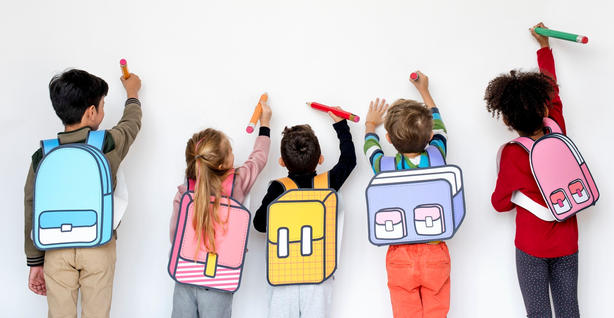 Children in classroom raising hands